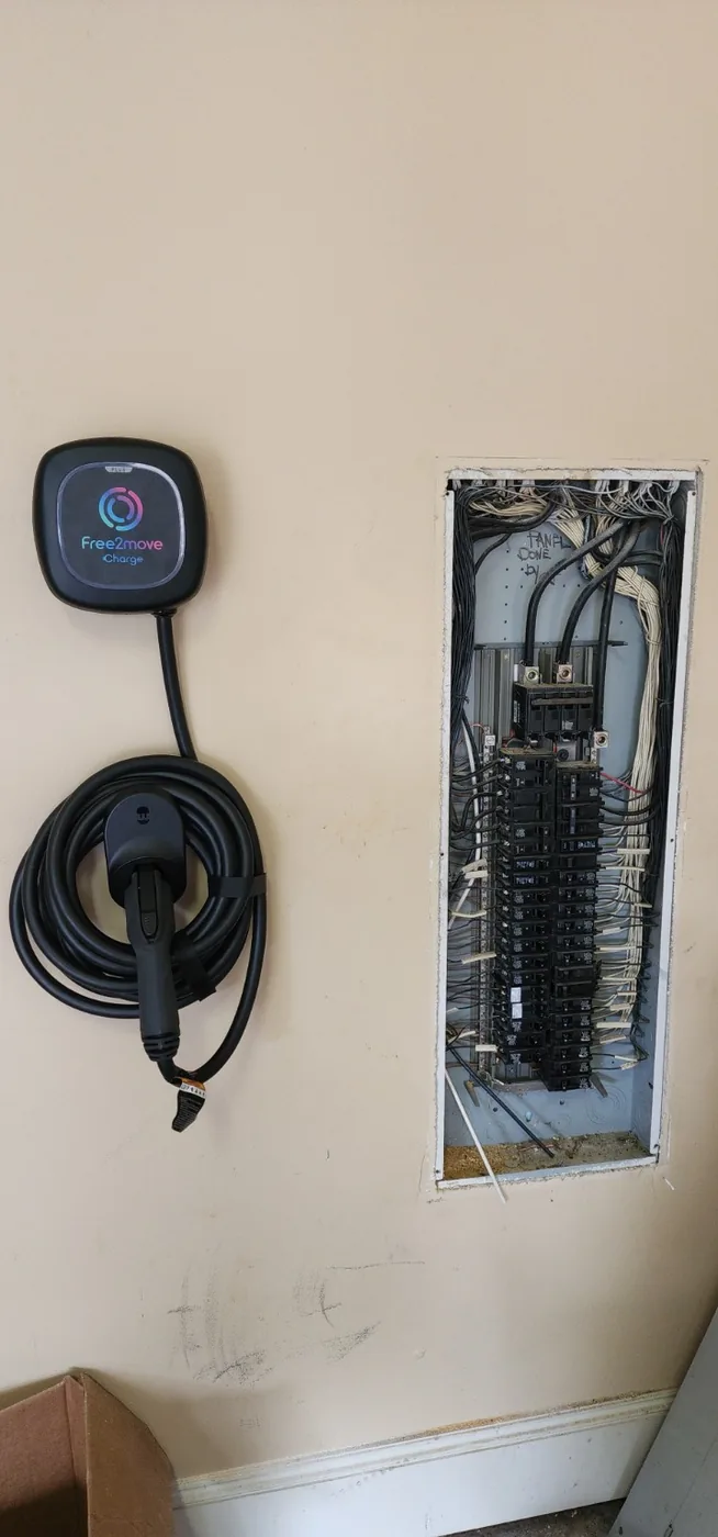 EV charger installed beside a residential electrical panel